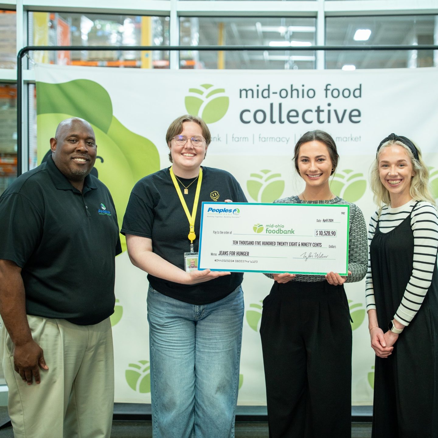 Three Peoples Bank employees present a check to the Mid-Ohio Food Collective.