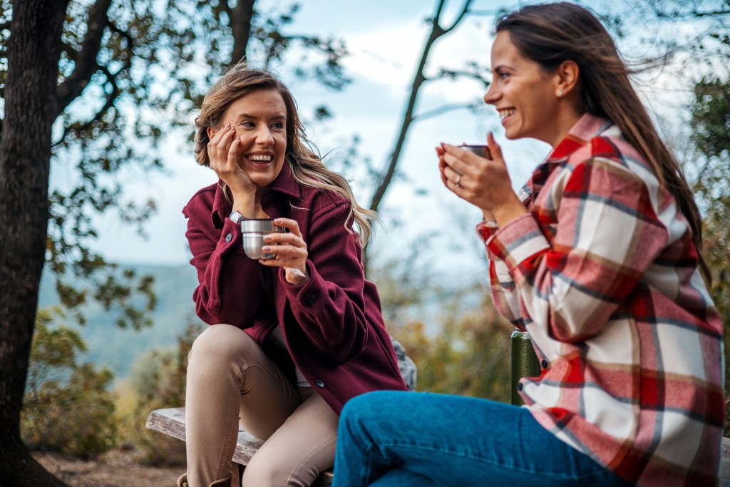 Female friends enjoy late afternoon day hike.