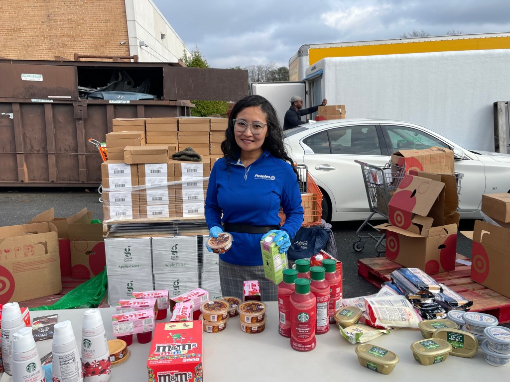 Peoples Bank employee packages canned goods for a local food drive.