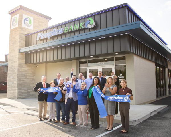 Peoples Bank associates celebrate the opening of a branch with a ribbon cutting ceremony.