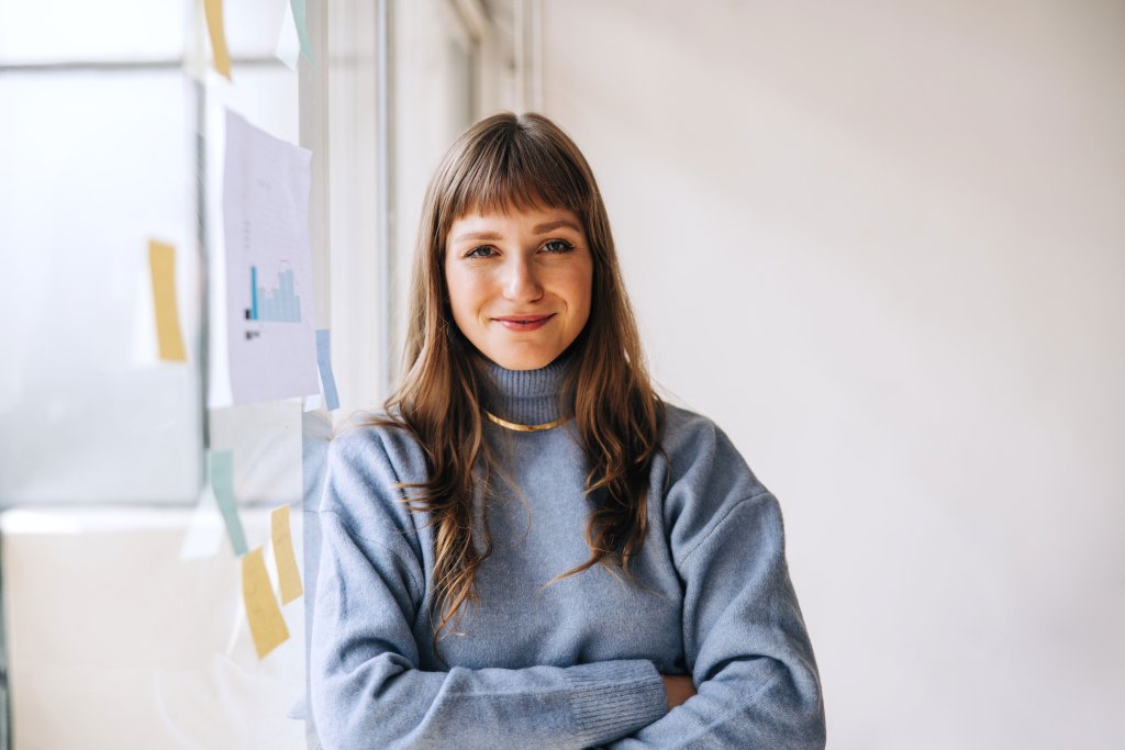 Portrait of a young businesswoman looking at the camera in an office.